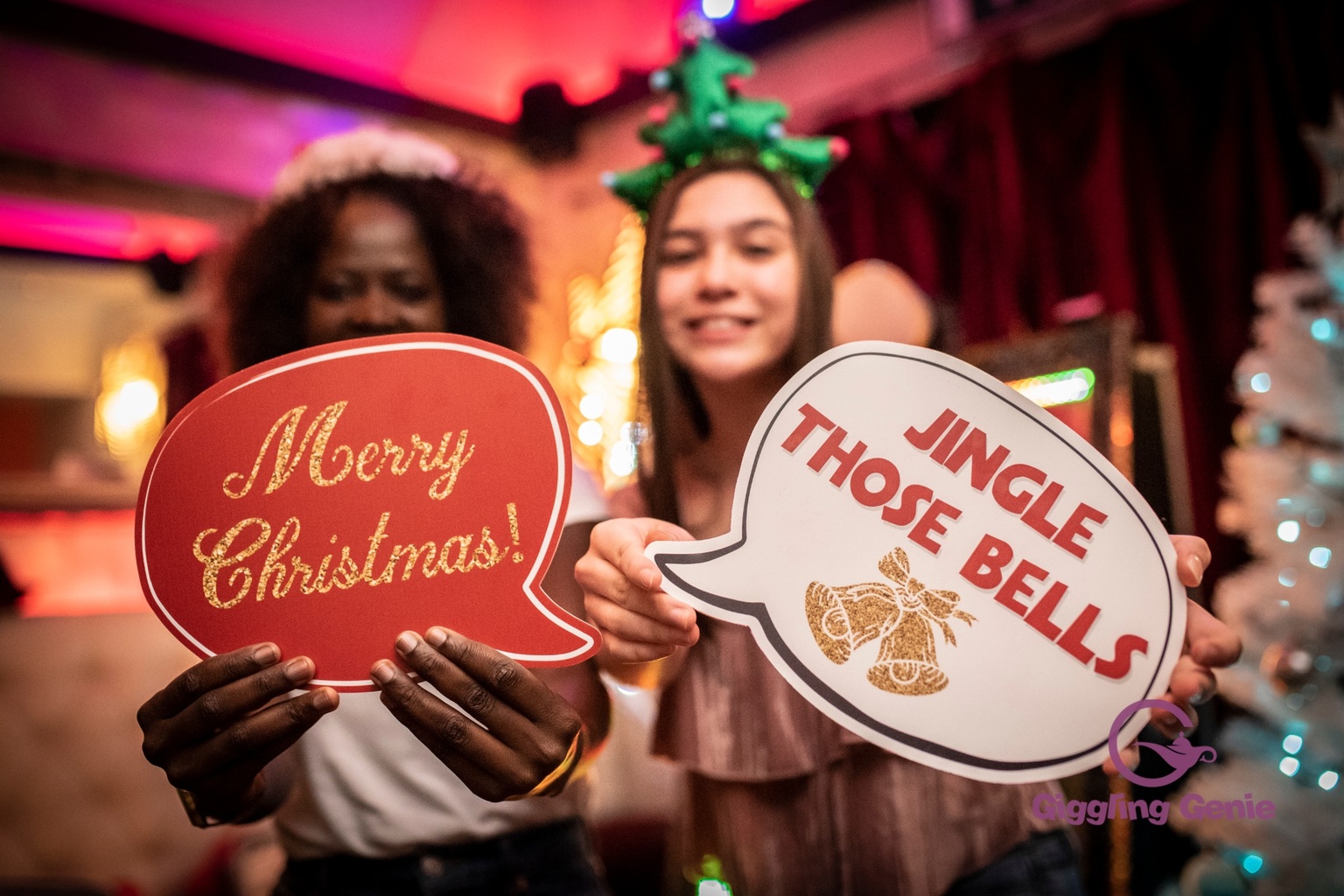 Guests enjoying Christmas photo booth props at a festive party in Surrey